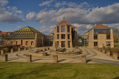 Gebäudeensemble aus Ziegelsteinen, links im Bild das Ziegeleimuseum mit bunten Dachziegeln